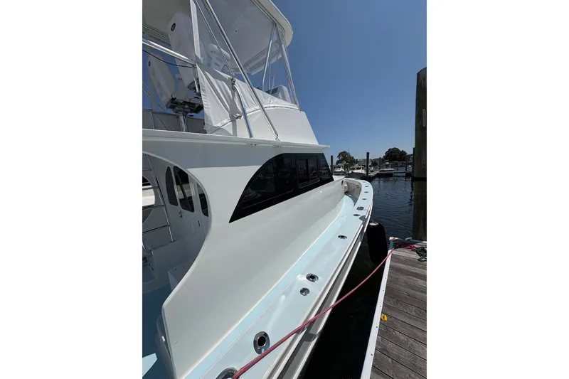 Slide: The Image of 2023 Millenium 37 Walk Around Fly Bridge Sportfish docked at marina. - 52