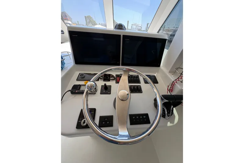 Slide: The Image of Helm of 2023 Millenium 37 Walk Around Fly Bridge Sportfish with dual screens and controls. - 53