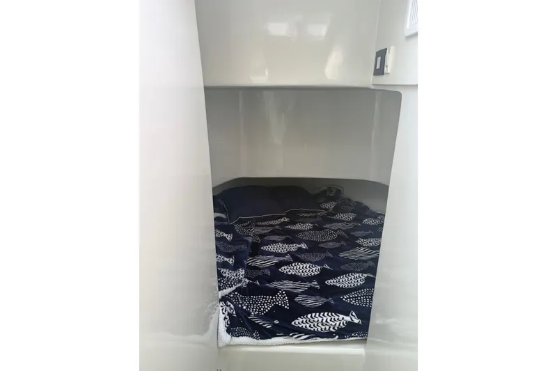 Slide: The Image of Cozy cabin interior of 2023 Millenium 37 Walk Around Fly Bridge Sportfish with fish-patterned bedding. - 55
