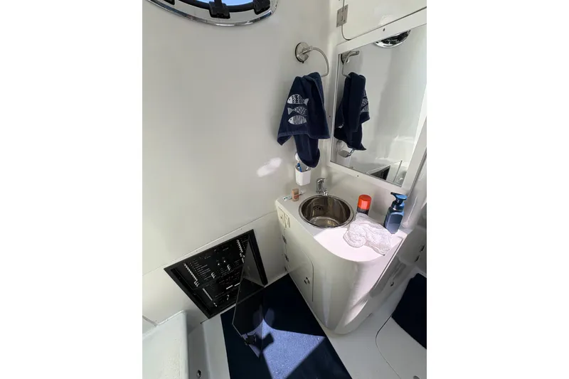 Slide: The Image of 2023 Millenium 37 Walk Around Fly Bridge Sportfish bathroom with sink and mirror. - 32