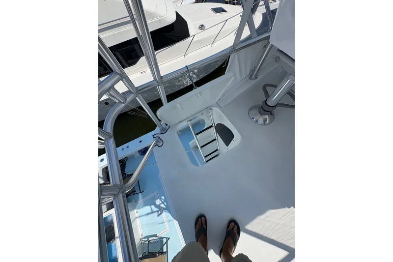Slide: The Image of 2023 Millenium 37 Walk Around Fly Bridge Sportfish deck view with ladder and railing. - 27
