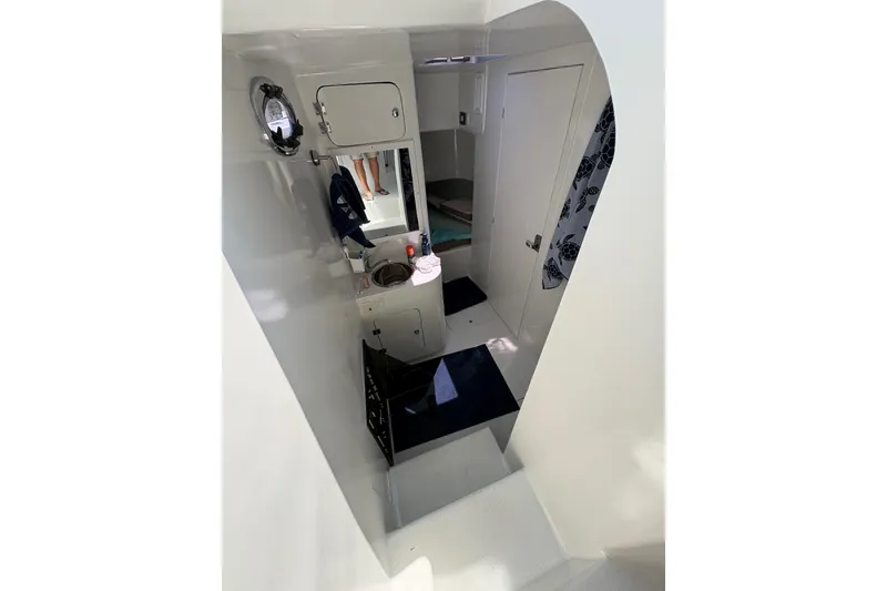 Slide: The Image of Interior of 2023 Millenium 37 Walk Around Fly Bridge Sportfish, featuring compact cabin amenities. - 18