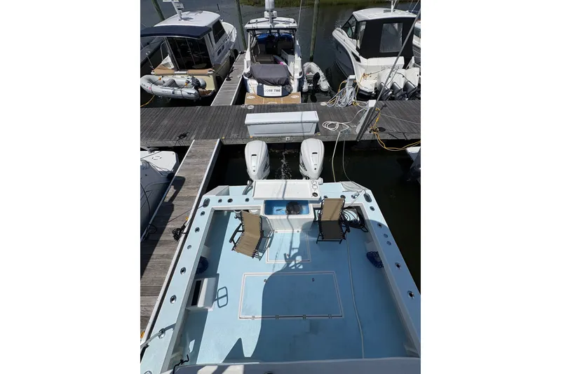 Slide: The Image of 2023 Millenium 37 Walk Around Fly Bridge Sportfish docked with twin engines. - 40