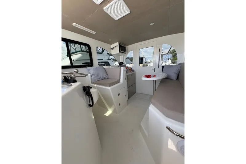 Slide: The Image of Interior of 2023 Millenium 37 Walk Around Fly Bridge Sportfish, featuring seating and table. - 38