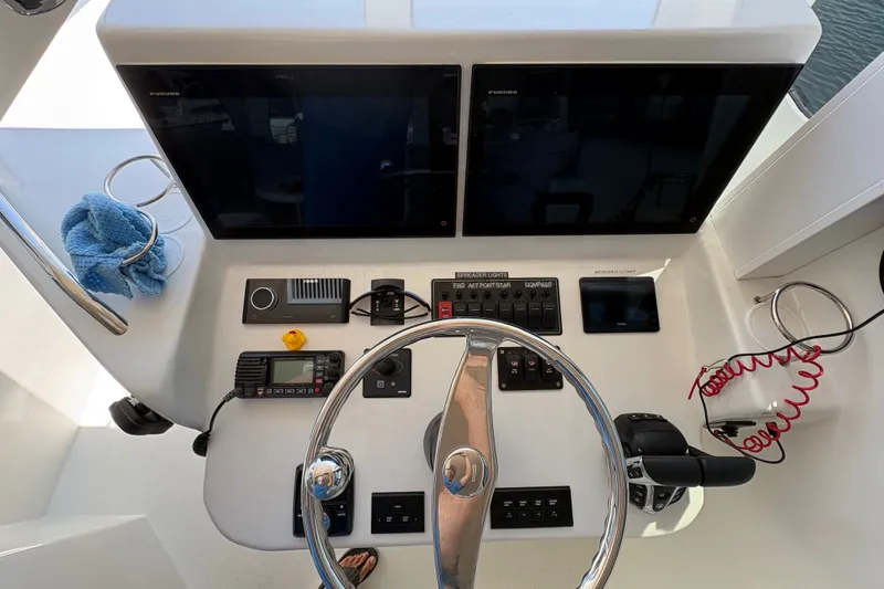 Slide: The Image of Helm of 2023 Millenium 37 Walk Around Fly Bridge Sportfish with navigation controls. - 19