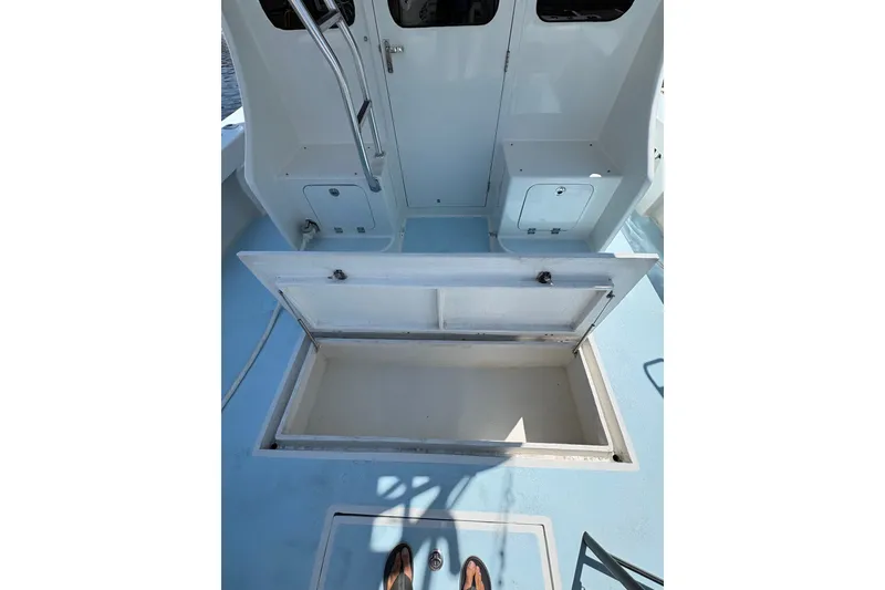 Slide: The Image of 2023 Millenium 37 Walk Around Fly Bridge Sportfish boat interior with open storage compartment. - 50