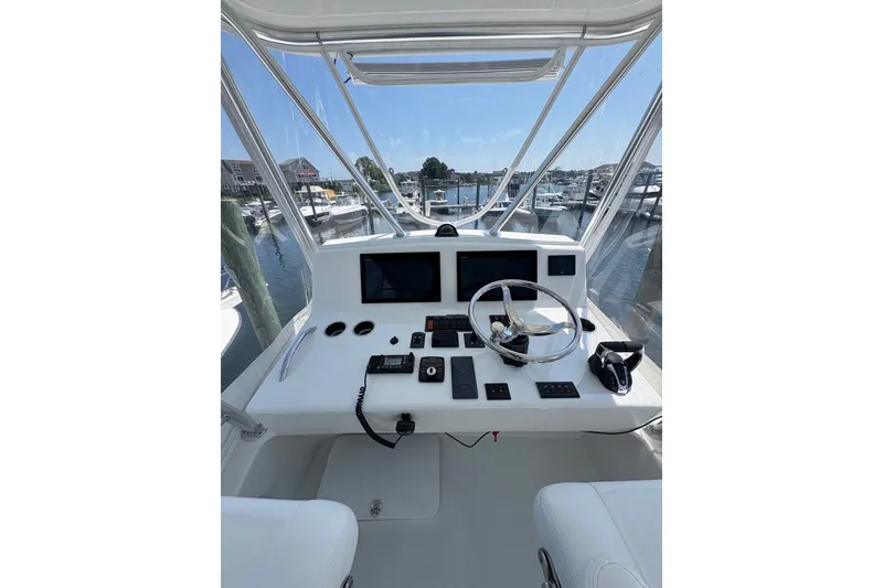 Slide: The Image of Helm of 2023 Millenium 37 Walk Around Fly Bridge Sportfish, featuring modern controls and navigation. - 34