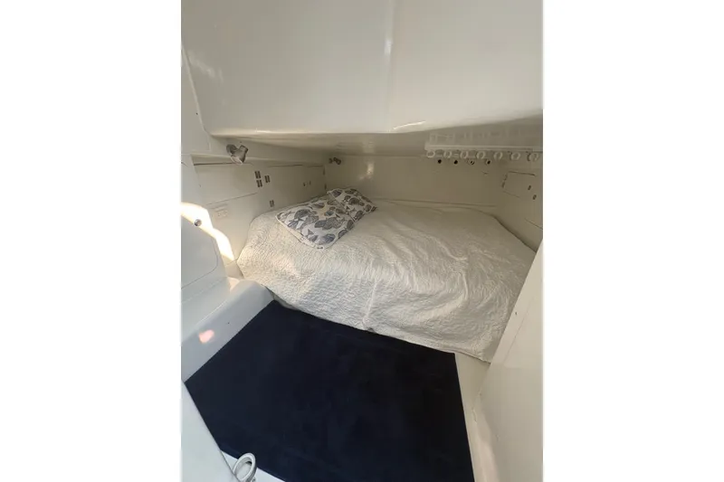 Slide: The Image of 2023 Millenium 37 Walk Around Fly Bridge Sportfish cabin interior with bed and pillow. - 60