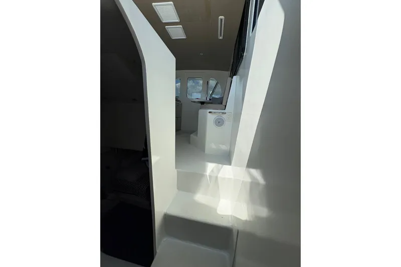 Slide: The Image of Interior view of 2023 Millenium 37 Walk Around Fly Bridge Sportfish, showcasing sleek white design. - 42