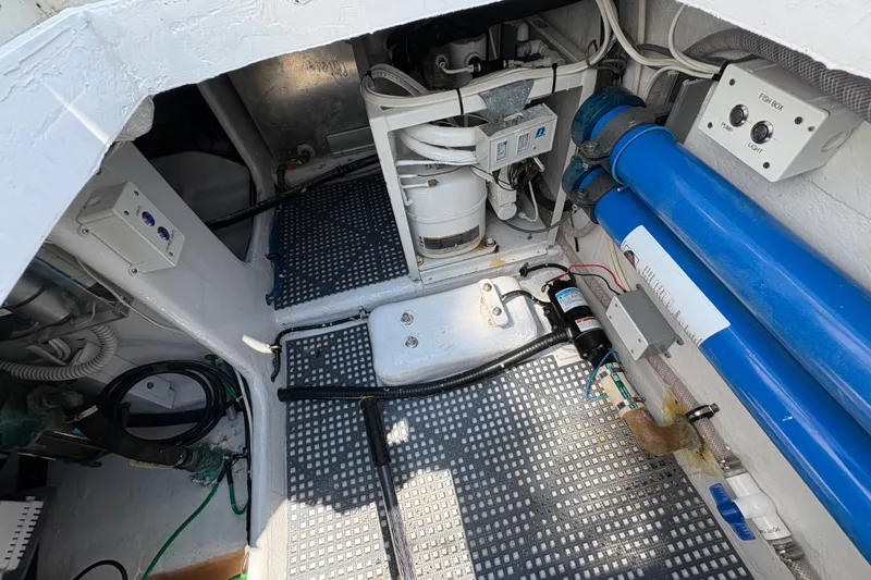 Slide: The Image of Engine room of 2023 Millenium 37 Walk Around Fly Bridge Sportfish, showcasing equipment and wiring. - 29