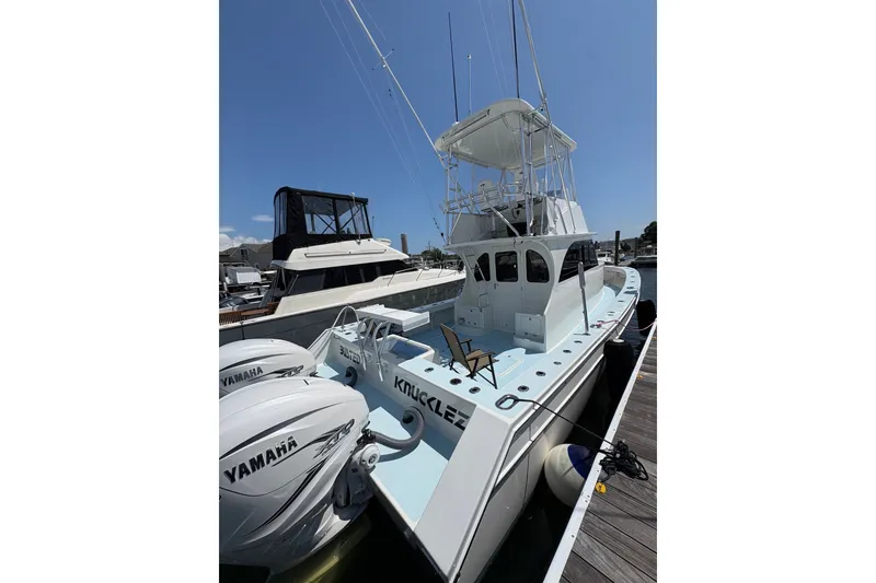 Slide: The Image of 2023 Millenium 37 Walk Around Fly Bridge Sportfish boat docked with Yamaha engines. - 54