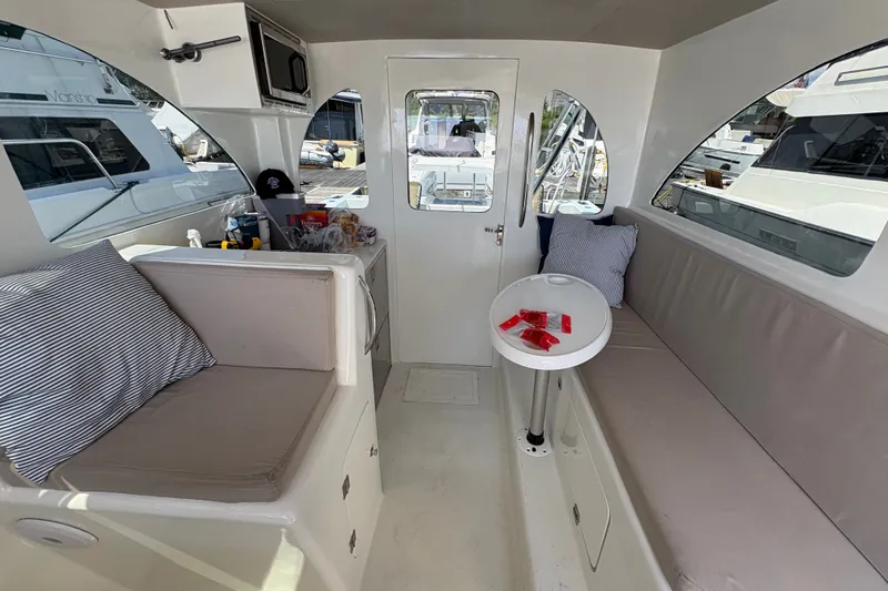 Slide: The Image of Interior of 2023 Millenium 37 Walk Around Fly Bridge Sportfish boat, featuring seating and table. - 16