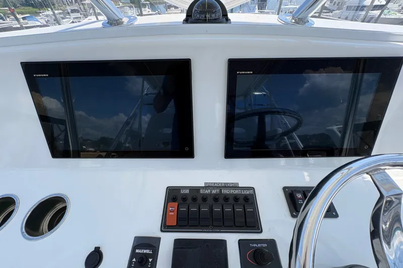 Slide: The Image of 2023 Millenium 37 Walk Around Fly Bridge Sportfish dashboard with dual Furuno displays. - 36