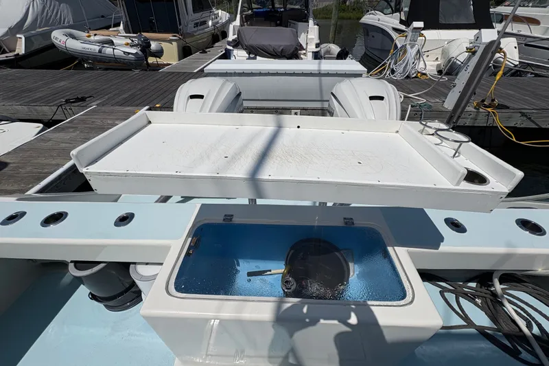 Slide: The Image of 2023 Millenium 37 Walk Around Fly Bridge Sportfish boat with fishing station and livewell at dock. - 23