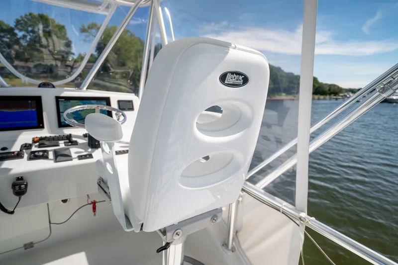 Slide: The Image of 2023 Millennium Marine 37 Walk Around Fly Bridge Sportfish helm with modern controls and seating. - 75