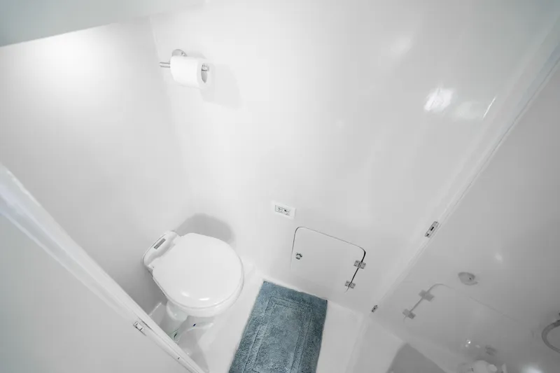 Slide: The Image of Compact bathroom in 2023 Millennium Marine 37 Walk Around Fly Bridge Sportfish boat. - 101