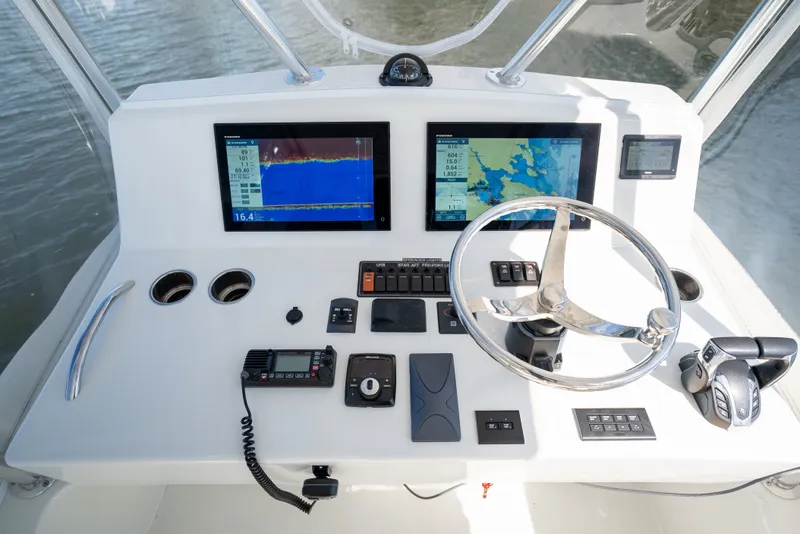 Slide: The Image of 2023 Millennium Marine 37 Walk Around Fly Bridge Sportfish helm with advanced navigation displays. - 77