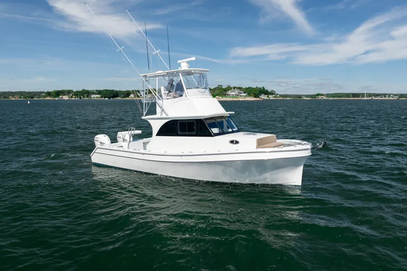 Slide: The Image of 2023 Millennium Marine 37 Walk Around Fly Bridge Sportfish on open water. - 61