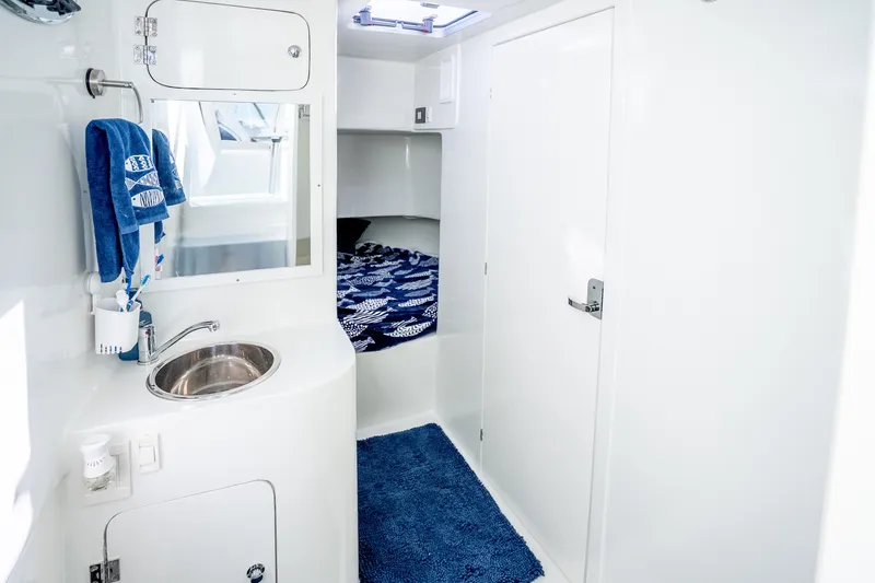 Slide: The Image of Interior of 2023 Millennium Marine 37 Walk Around Fly Bridge Sportfish, featuring a sleek bathroom design. - 98