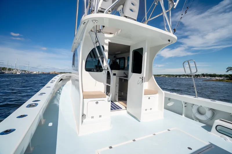 Slide: The Image of 2023 Millennium Marine 37 Walk Around Fly Bridge Sportfish on open water, showcasing sleek design. - 85