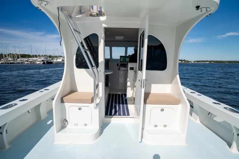 Slide: The Image of 2023 Millennium Marine 37 Walk Around Fly Bridge Sportfish on open water, showcasing interior and seating. - 84