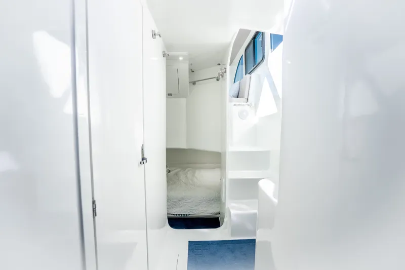 Slide: The Image of Interior cabin of 2023 Millennium Marine 37 Walk Around Fly Bridge Sportfish, featuring sleek white design. - 99