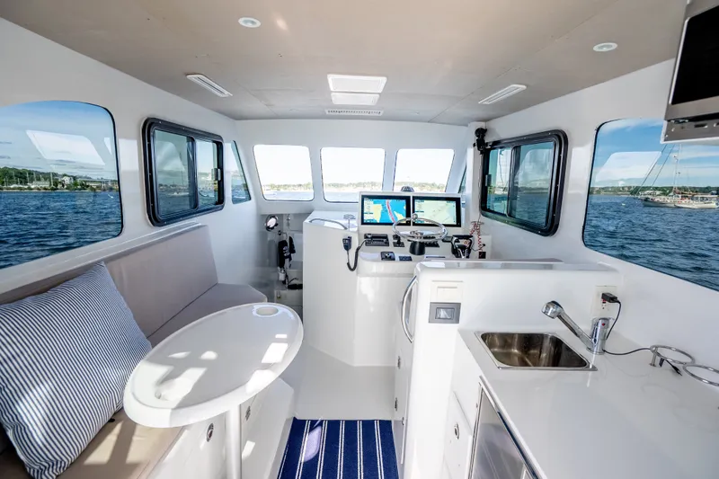 Slide: The Image of Interior of 2023 Millennium Marine 37 Walk Around Fly Bridge Sportfish, featuring helm and seating area. - 89