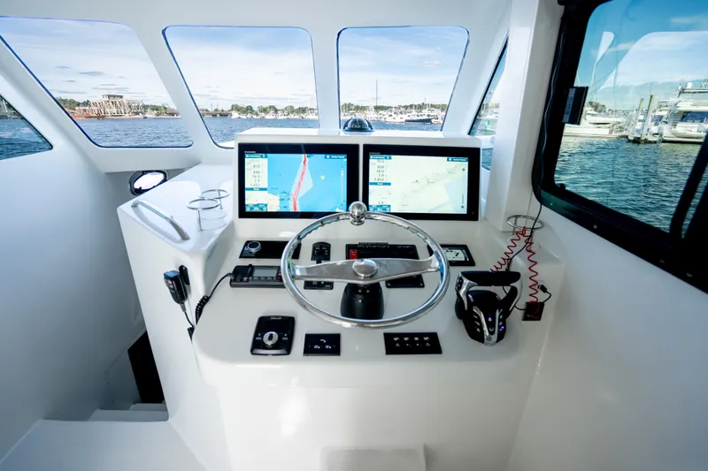 Slide: The Image of Helm of 2023 Millennium Marine 37 Walk Around Fly Bridge Sportfish with navigation screens. - 93