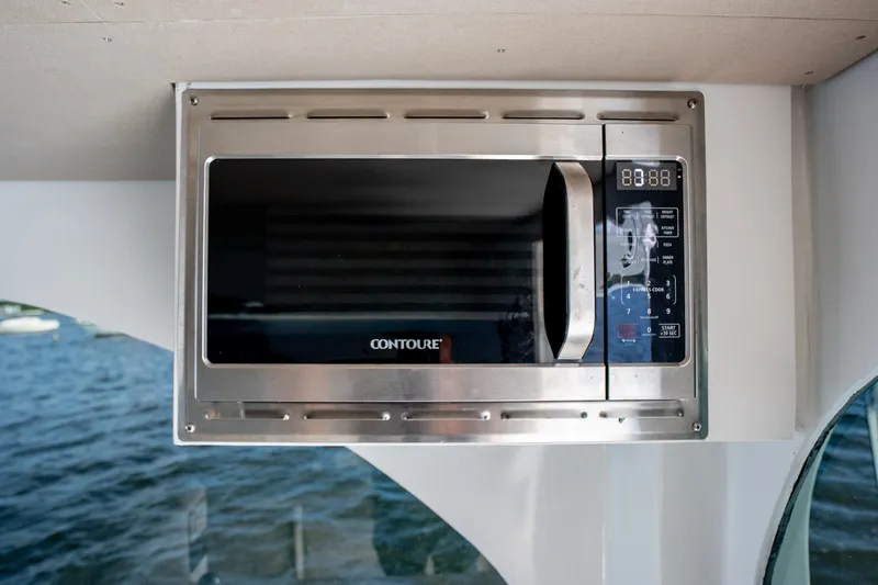 Slide: The Image of Built-in microwave on 2023 Millennium Marine 37 Walk Around Fly Bridge Sportfish boat. - 90