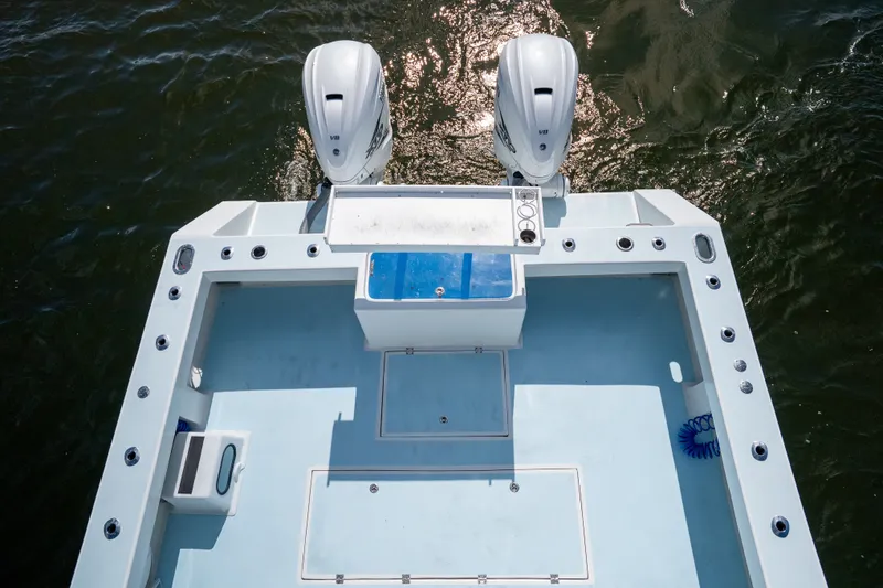 Slide: The Image of 2023 Millennium Marine 37 Walk Around Fly Bridge Sportfish boat deck with dual engines. - 79