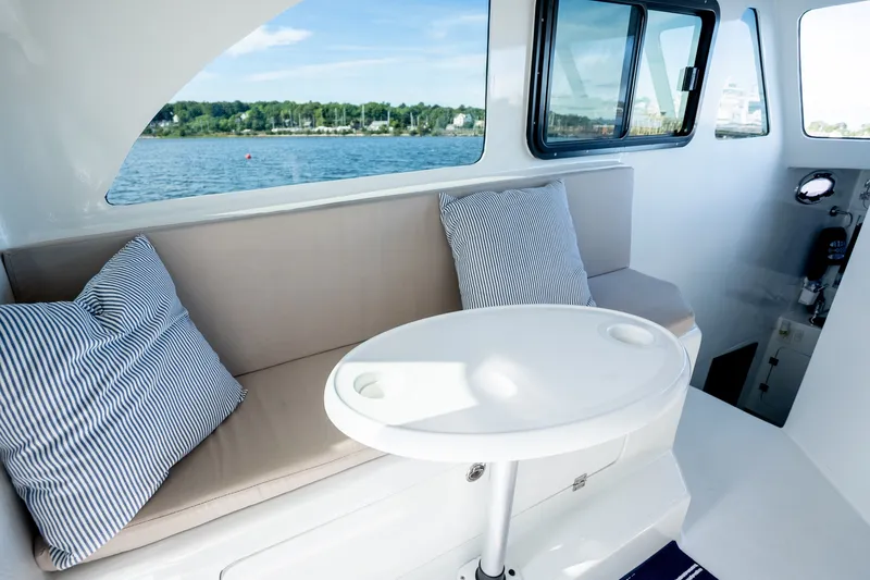 Slide: The Image of Interior of 2023 Millennium Marine 37 Walk Around Fly Bridge Sportfish with seating and table. - 92