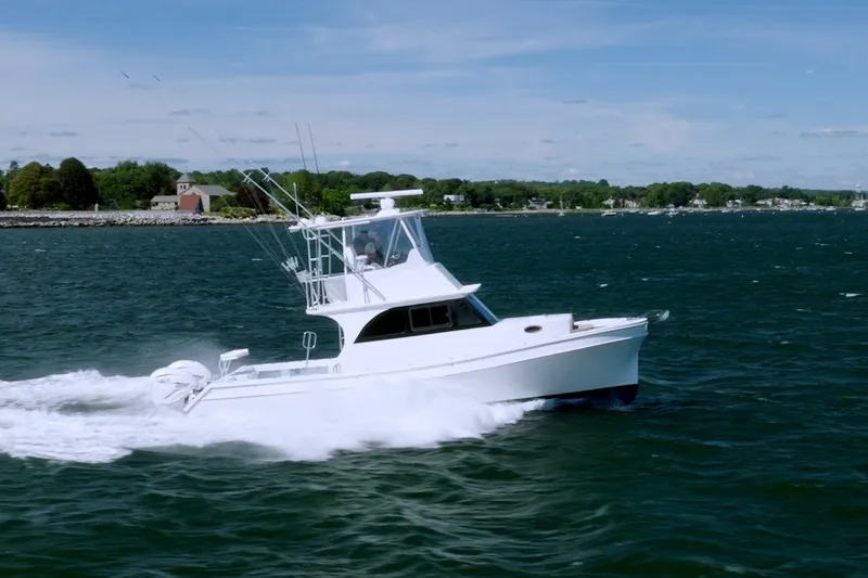 Slide: The Image of 2023 Millennium Marine 37 Walk Around Fly Bridge Sportfish cruising on open water. - 0