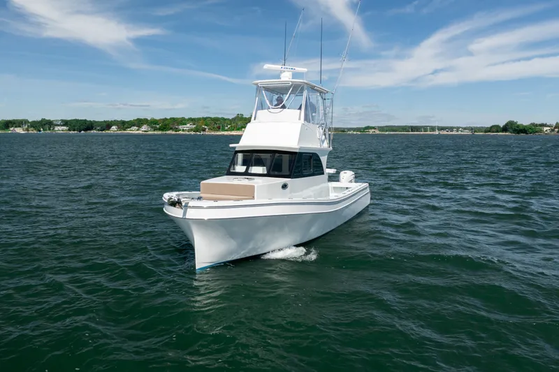 Slide: The Image of 2023 Millennium Marine 37 Walk Around Fly Bridge Sportfish on open water. - 64