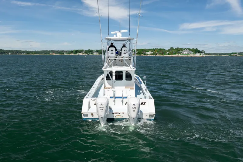 Slide: The Image of 2023 Millennium Marine 37 Walk Around Fly Bridge Sportfish on open water, rear view. - 67