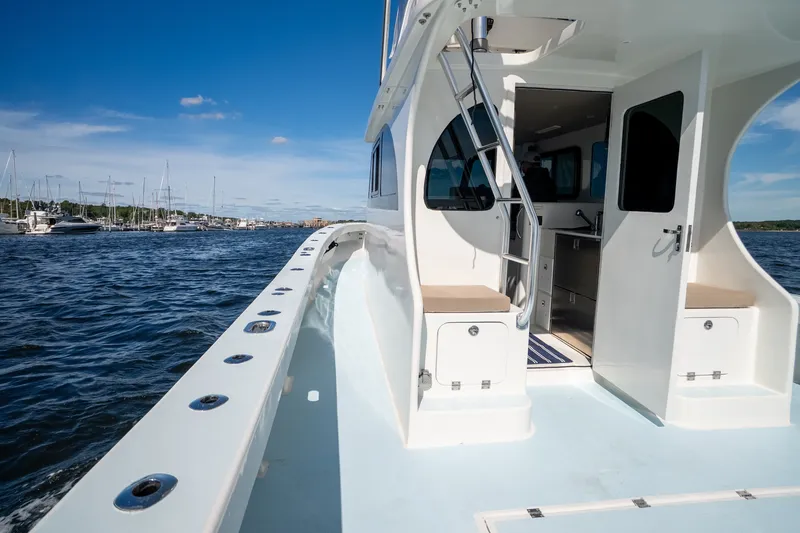 Slide: The Image of 2023 Millennium Marine 37 Walk Around Fly Bridge Sportfish on open water, showcasing sleek design. - 87