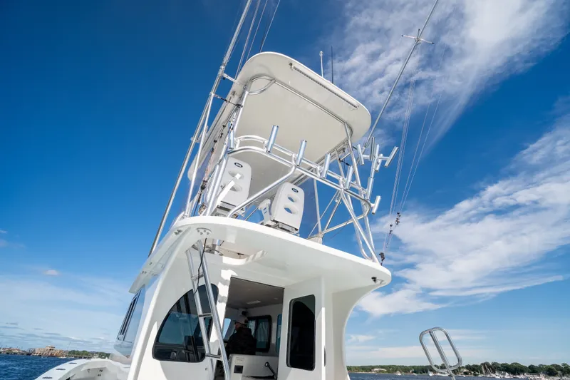Slide: The Image of 2023 Millennium Marine 37 Walk Around Fly Bridge Sportfish under clear blue sky. - 86
