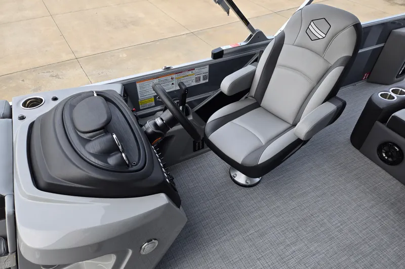 Slide: The Image of The image shows the helm of a South Bay SS224UL2.75 boat with a cushioned captain's chair. - 7