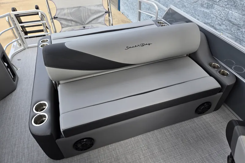 Slide: The Image of The image shows a gray bench seat on a boat with cup holders and speakers. - 8