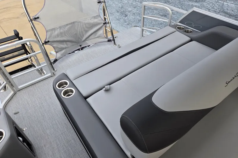 Slide: The Image of The image shows the gray and black upholstery of a 2027 South Bay SS224UL2.75 with cup holders. - 9