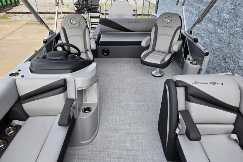 Slide: The Image of The image shows the interior of a 2027 South Bay SS224UL2.75 pontoon boat with gray seating. - 4
