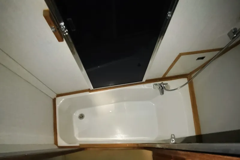 Slide: The Image of Bathroom interior of 1988 Bayliner 3818 Motoryacht with bathtub and showerhead. - 48