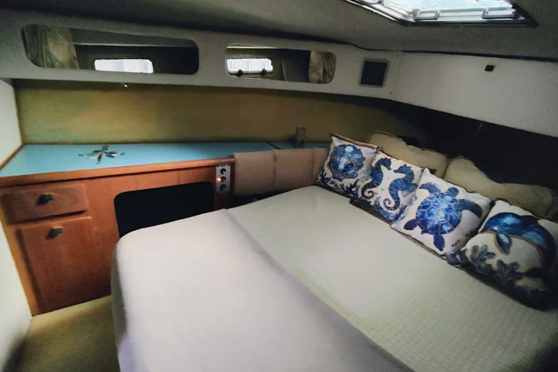 Slide: The Image of Cozy cabin interior of 1988 Bayliner 3818 Motoryacht with nautical-themed pillows. - 42