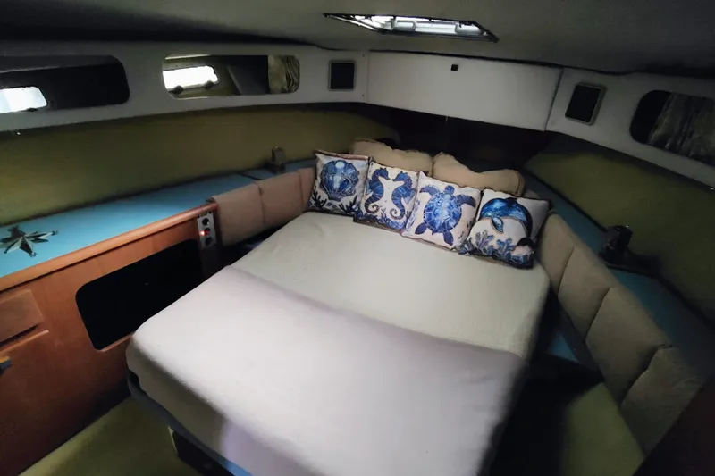 Slide: The Image of Cozy cabin interior of 1988 Bayliner 3818 Motoryacht with nautical-themed pillows. - 41