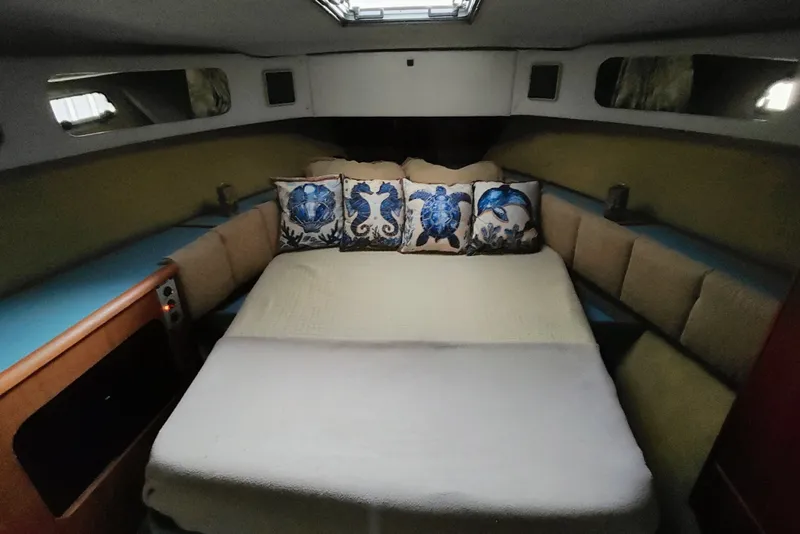Slide: The Image of Cozy cabin interior of 1988 Bayliner 3818 Motoryacht with marine-themed pillows. - 40