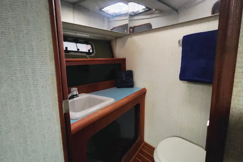 Slide: The Image of 1988 Bayliner 3818 Motoryacht bathroom with sink, mirror, and toilet. - 47