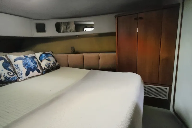 Slide: The Image of The image shows a cozy cabin with a large bed and a wooden wardrobe. - 43