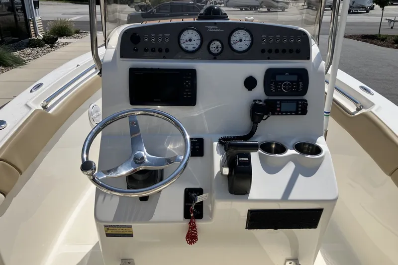 Slide: The Image of Center console of a 2017 Pioneer 202 Sportfish boat with steering wheel and controls. - 13