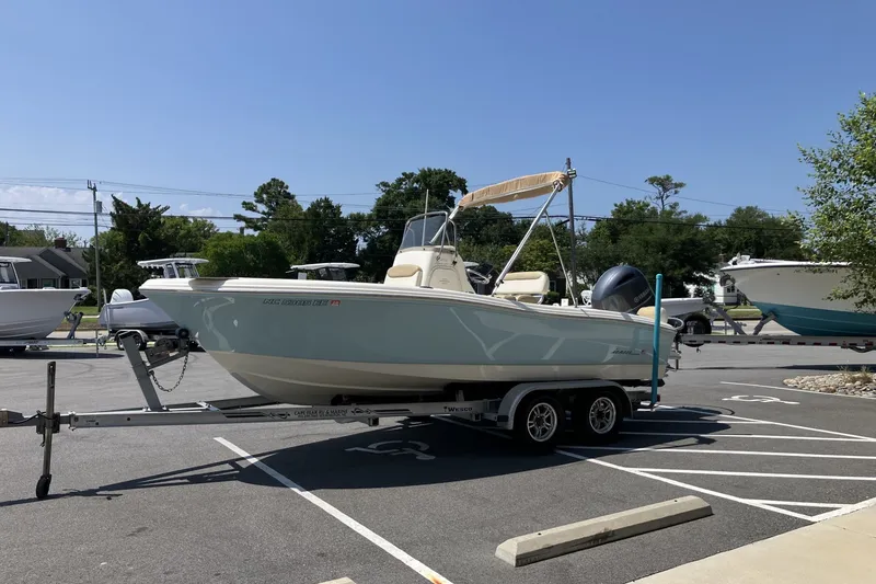 Slide: The Image of 2017 Pioneer 202 Sportfish boat on trailer in parking lot, sunny day. - 9