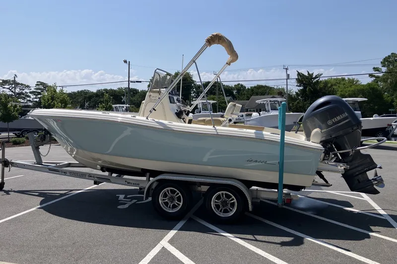 Slide: The Image of 2017 Pioneer 202 Sportfish boat on trailer, featuring Yamaha outboard motor, parked outdoors. - 8