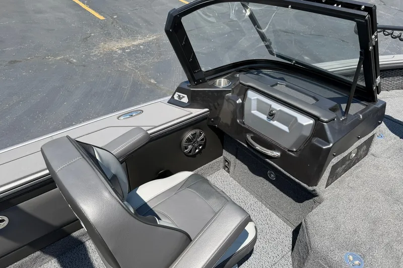 Slide: The Image of 2027 Lund 1875 Pro-V boat interior with gray seating and dashboard. - 11